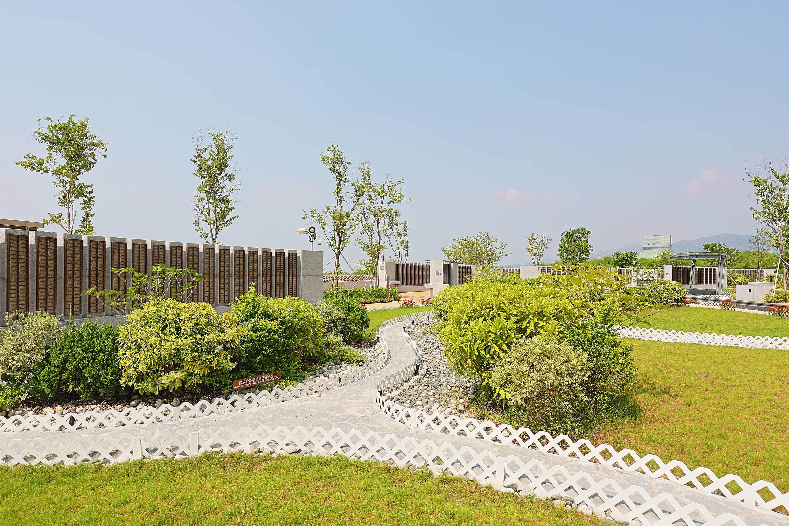 Memorial walls with mounting plaques at the Garden of Remembrance